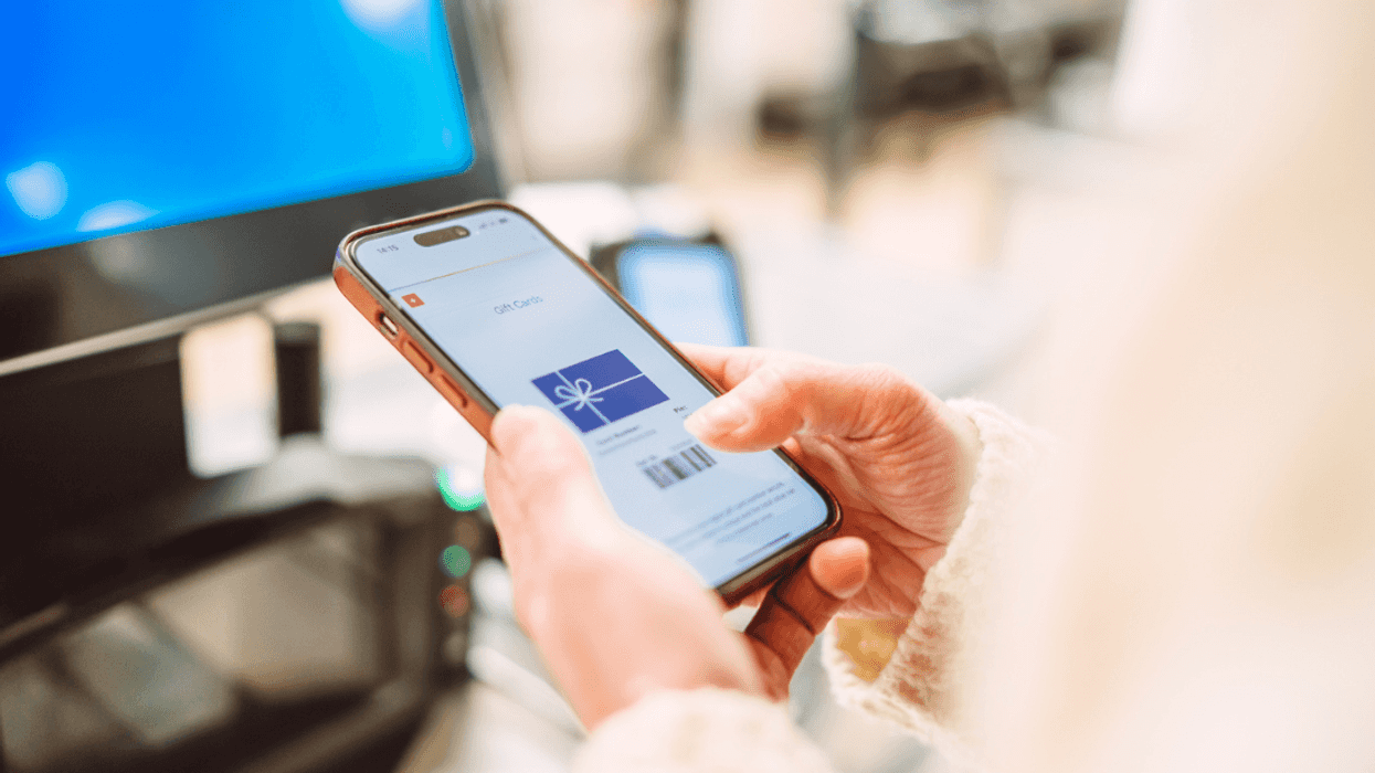 A person with a digital gift card on their phone.