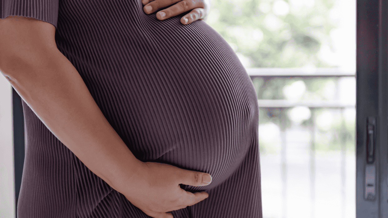 A pregnant woman holding her belly