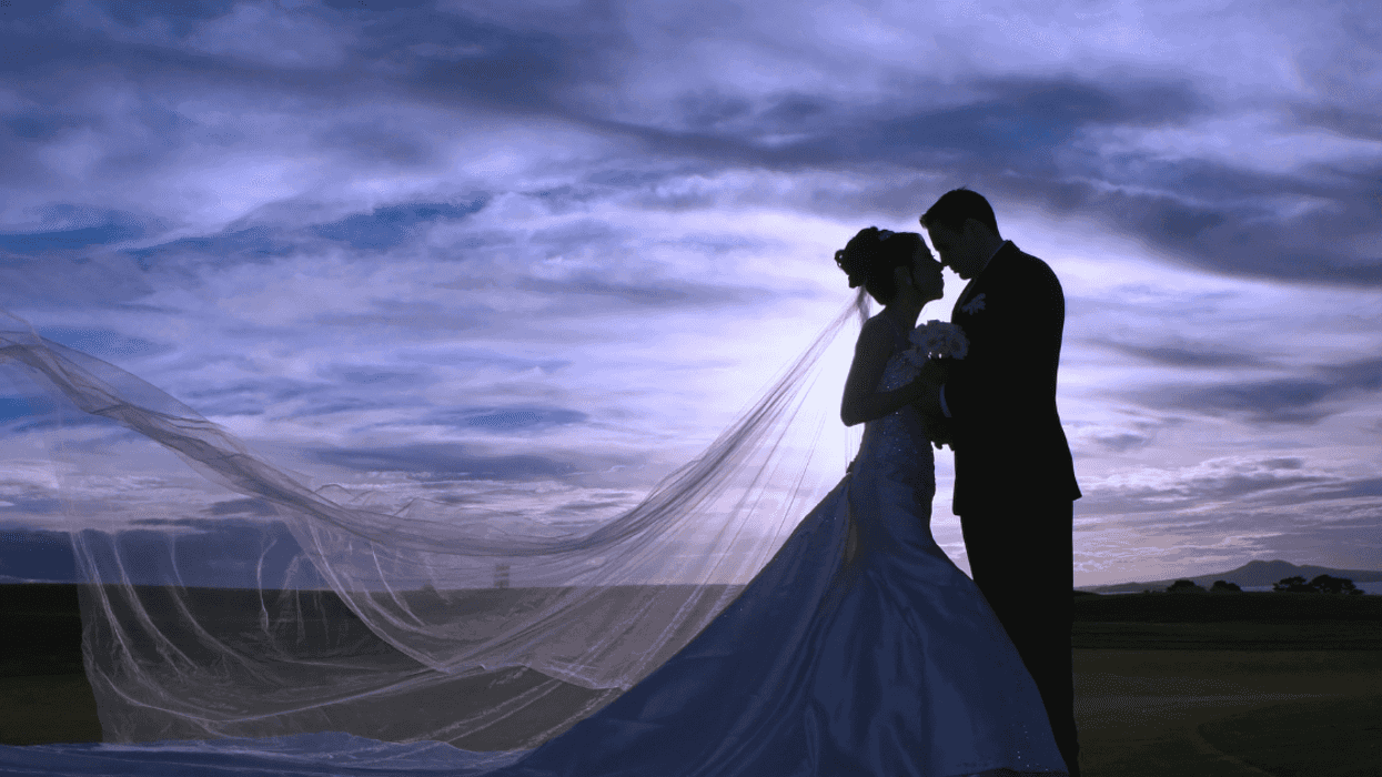 A silhouette of a bride and groom.