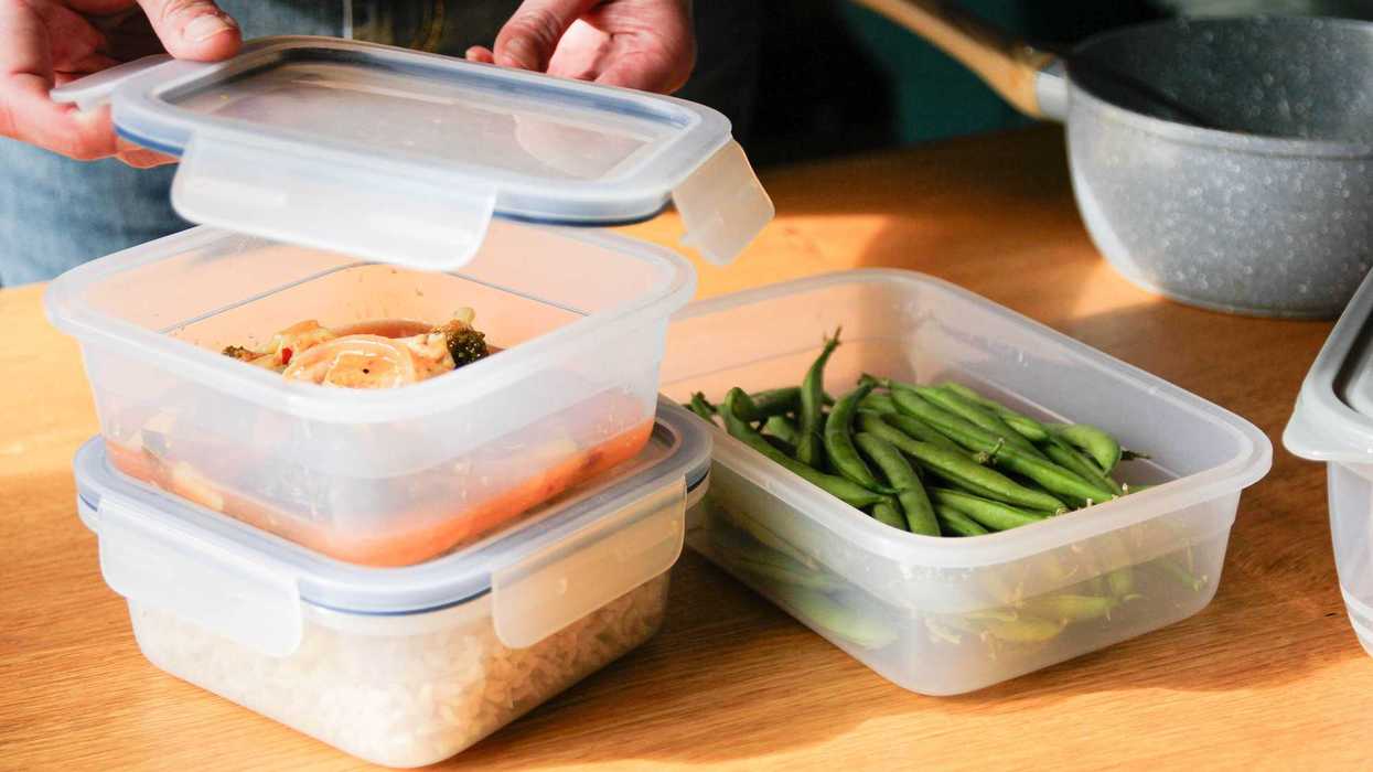A stack of tupperware filled with leftover food.