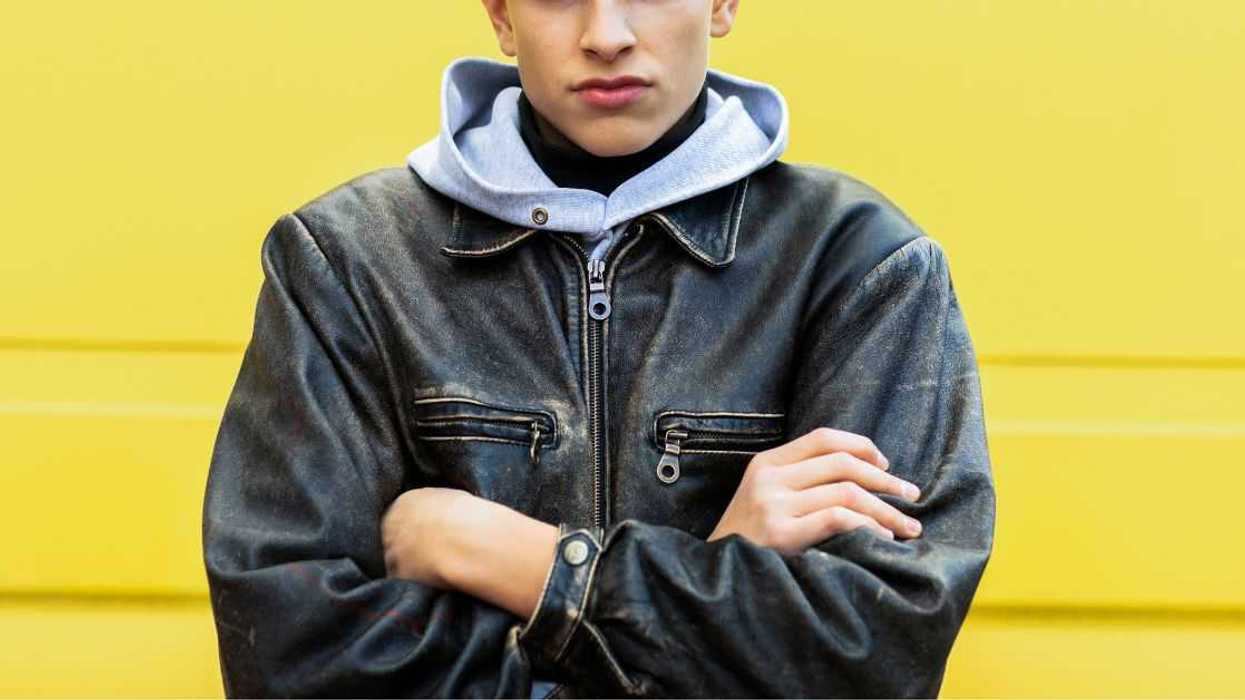 A teen boy crossing his arms