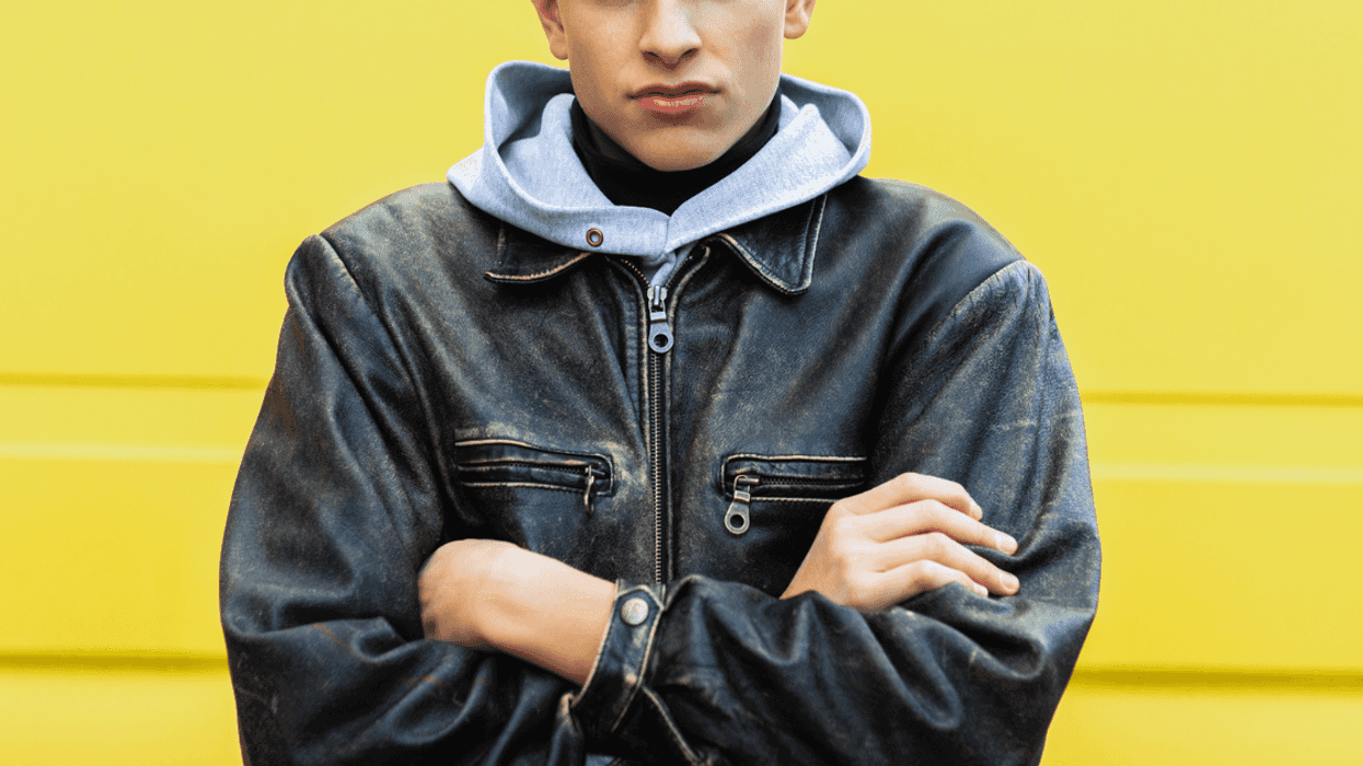 A teenage boy with his arms crossed.