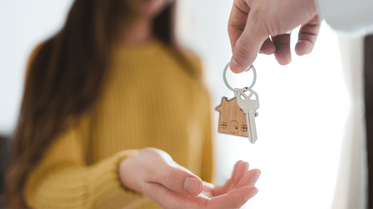 A woman being handed house keys.