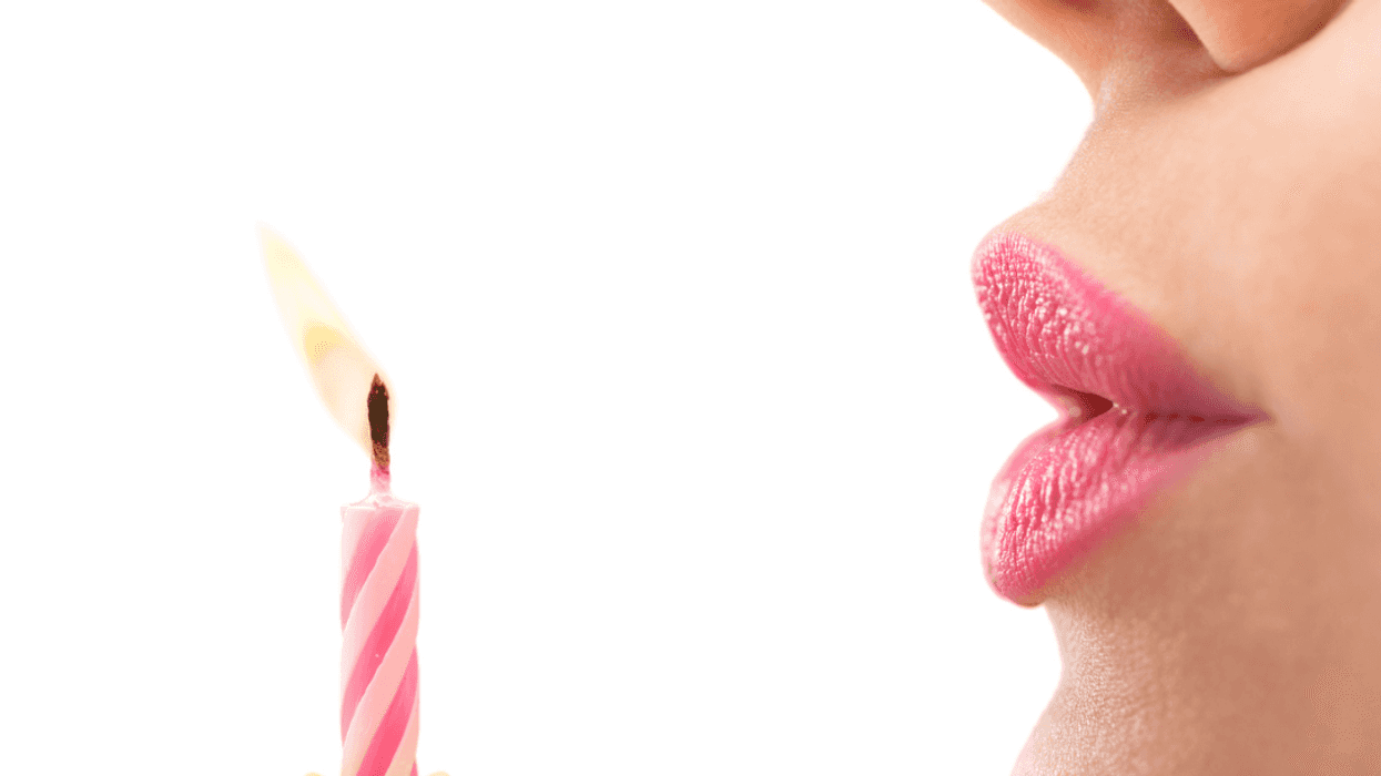 A woman blowing out a birthday candle