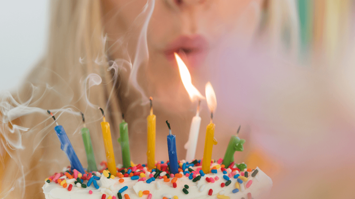 A woman blowing out birthday candles