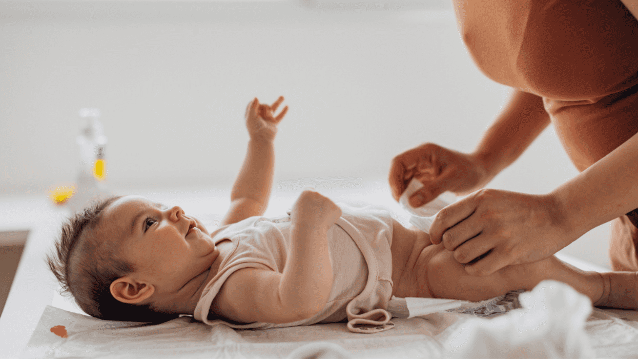 A woman changing a baby's diaper.