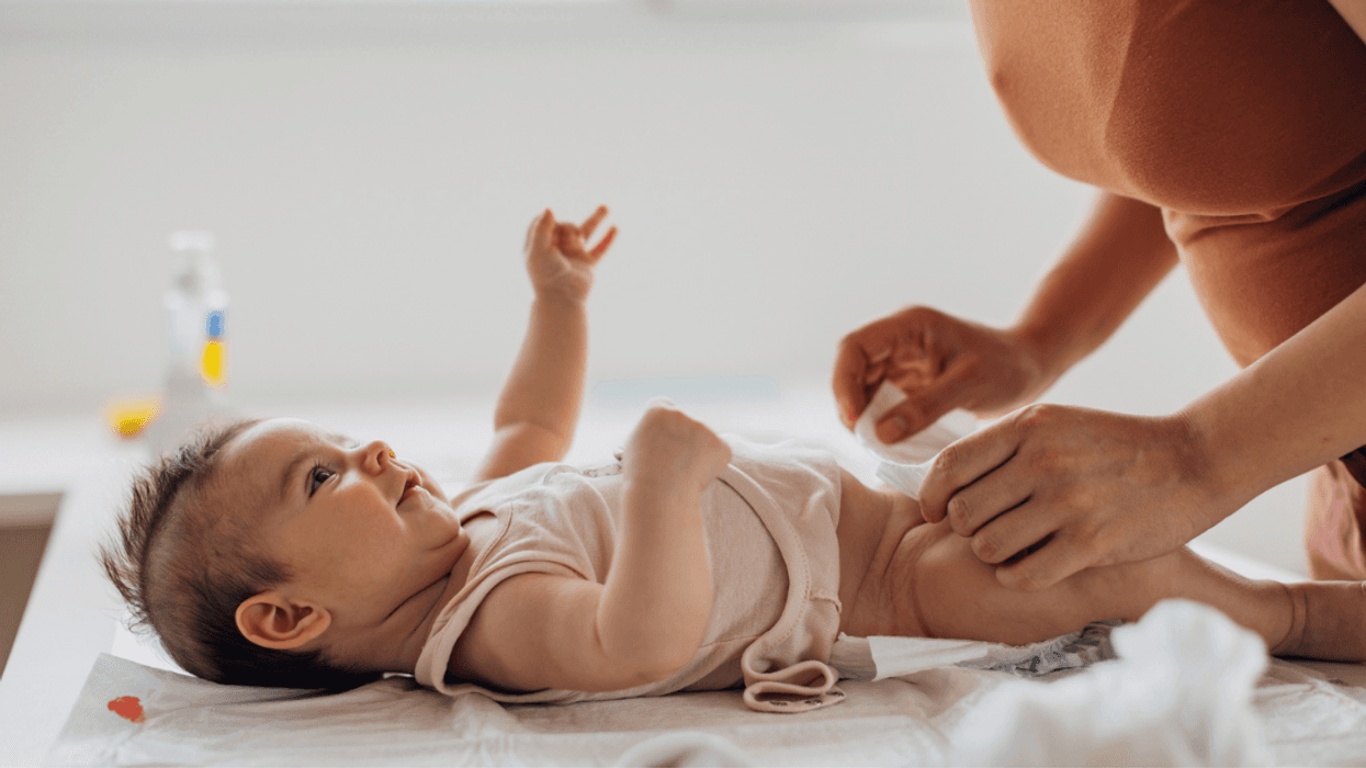 A woman changing a baby's diaper.