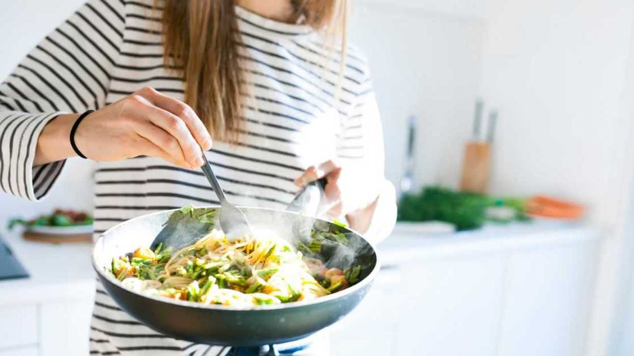 A woman cooks up a pasta dish