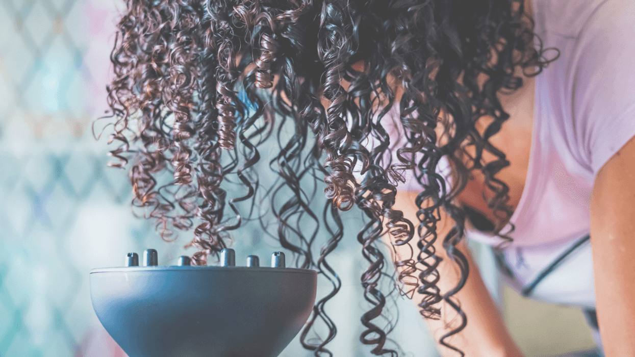 A woman drying her curly hair.