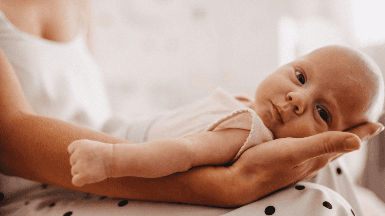 A woman holding a baby girl in her lap.