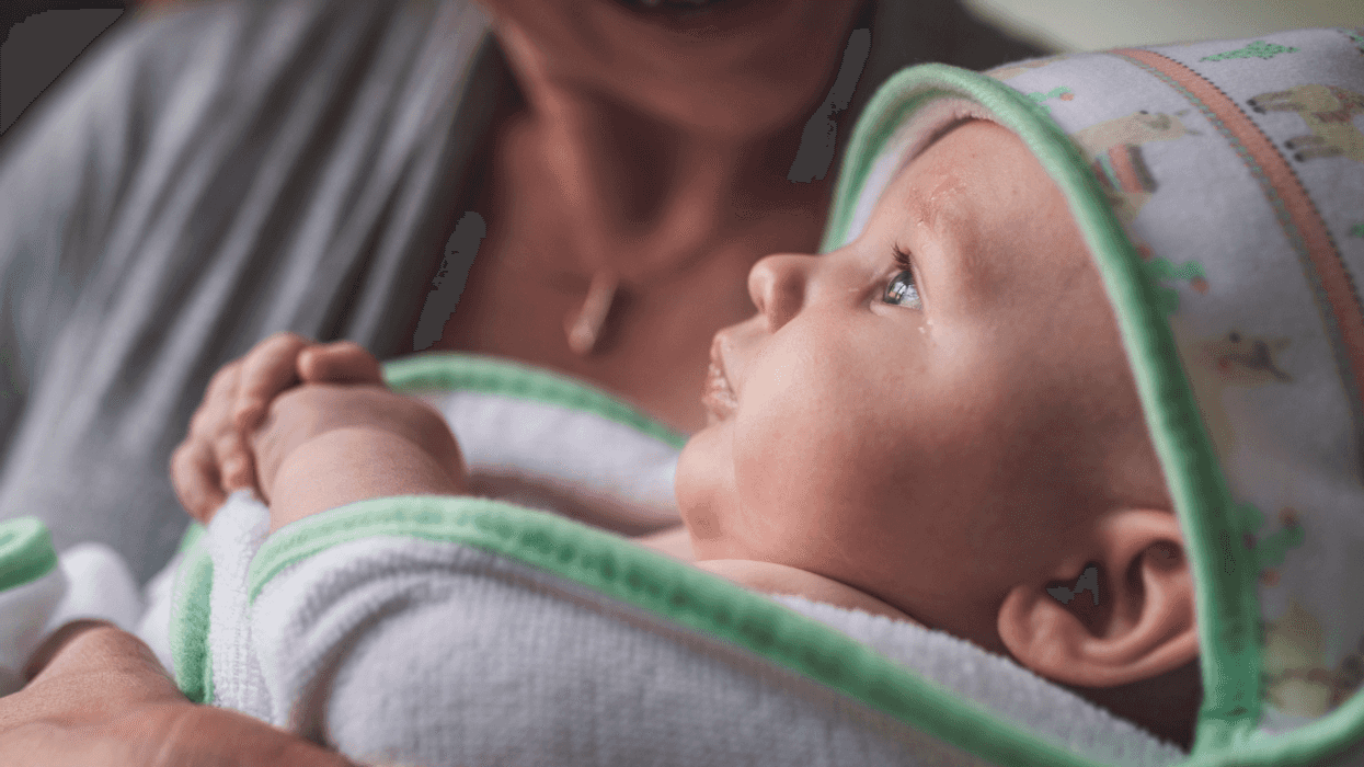 A woman holding a baby.