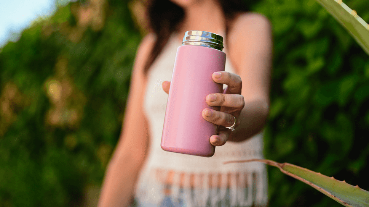 A woman holding a metal