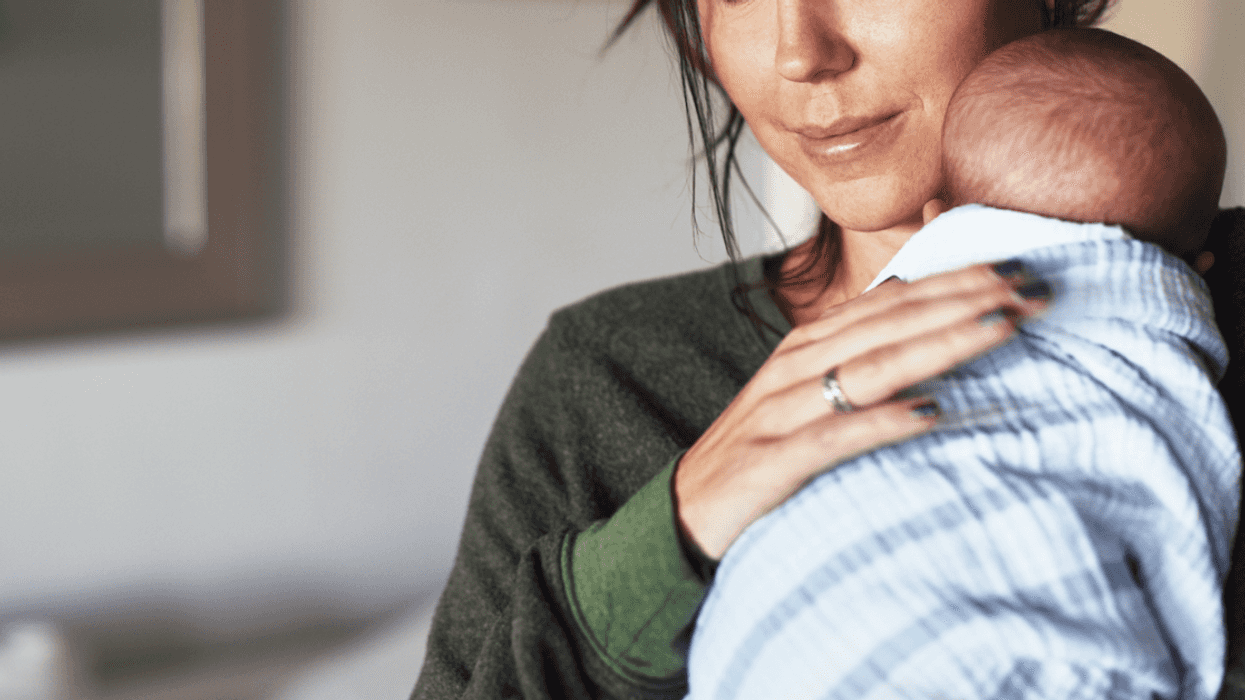 A woman holding a newborn baby.