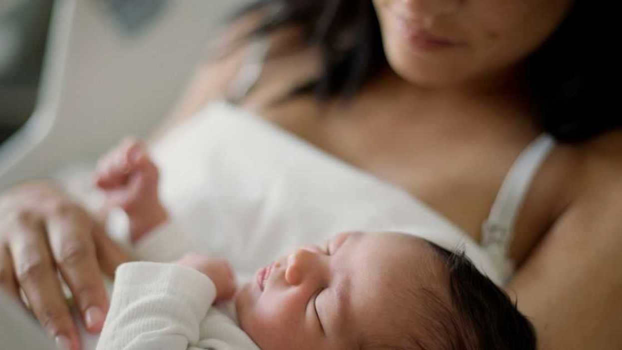 A woman holds a baby