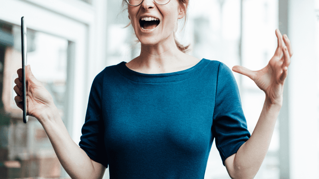 A woman in a blue top screaming