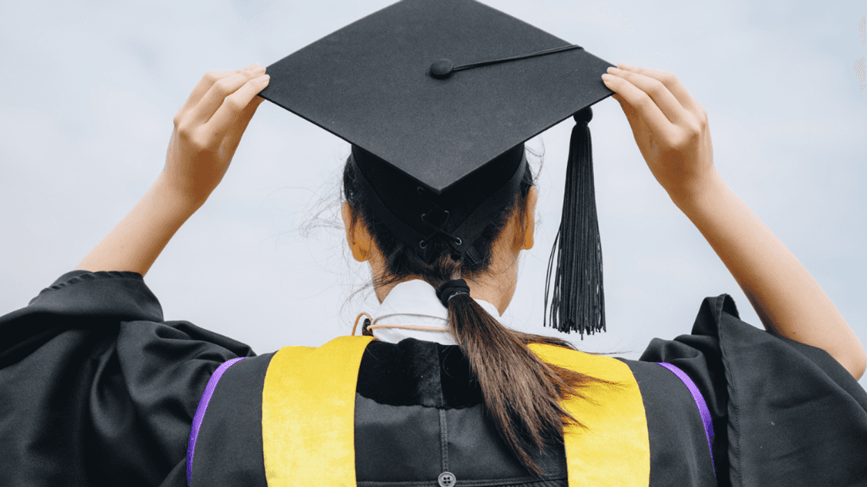 A woman in a graduation cap and gown.
