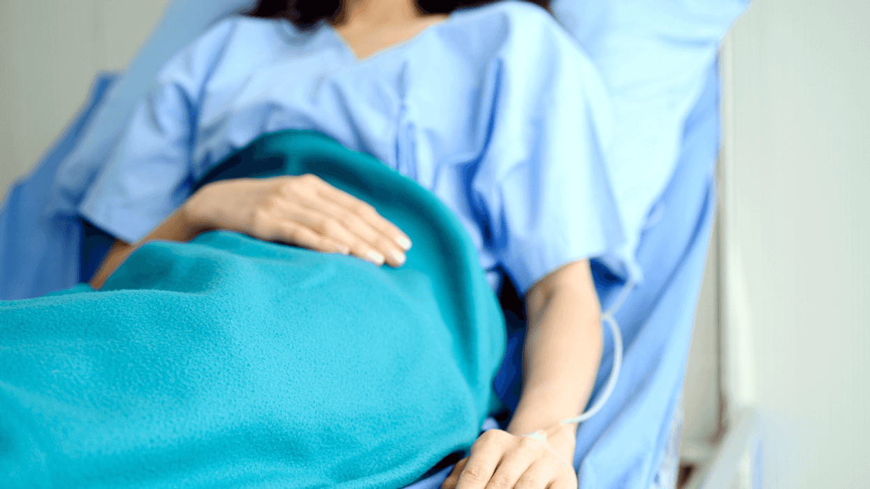A woman in a hospital bed.