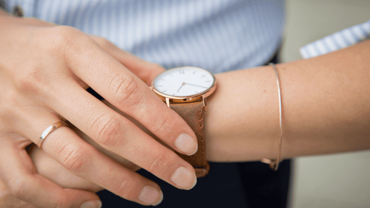 A woman looking at her watch.