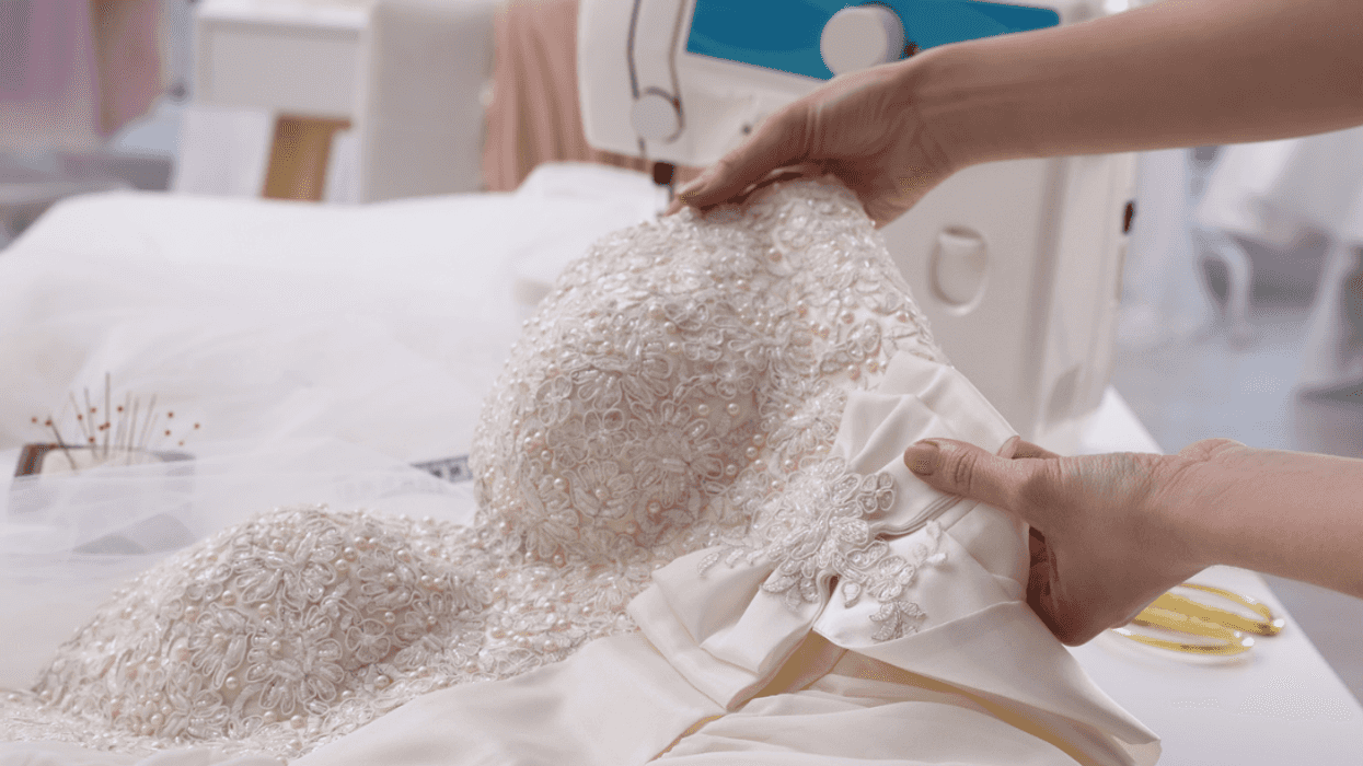 A woman making alterations to a wedding dress