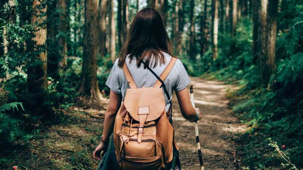 A woman on a hiking path, with her back to the camera