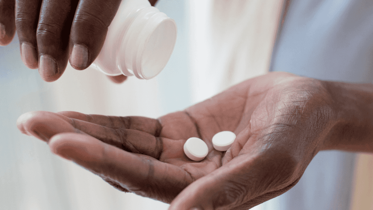 A woman pouring pills into her hands.
