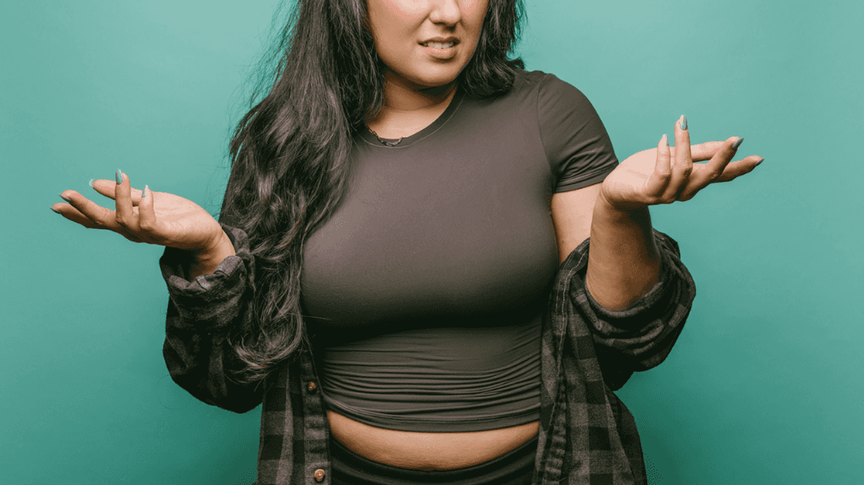 A woman shrugging her shoulders and holding out her hands.