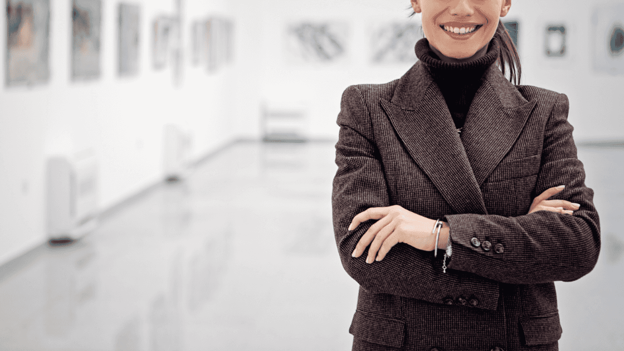 A woman standing in an art gallery.