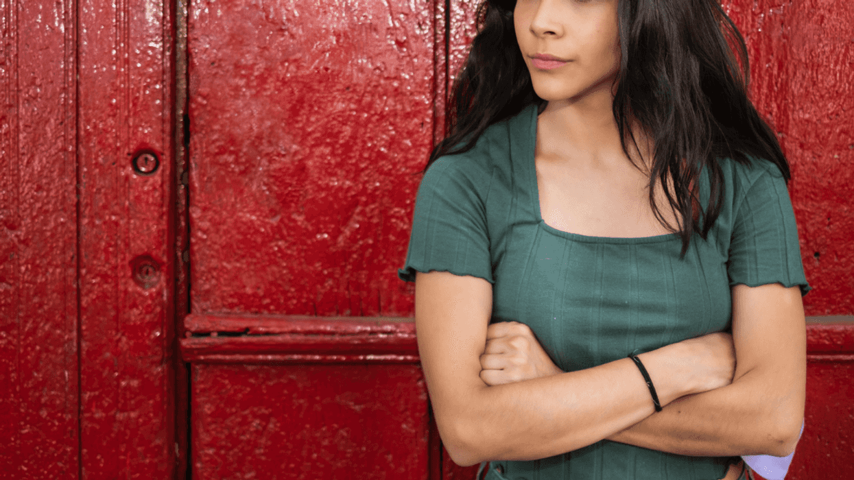 A woman standing with her arms crossed.