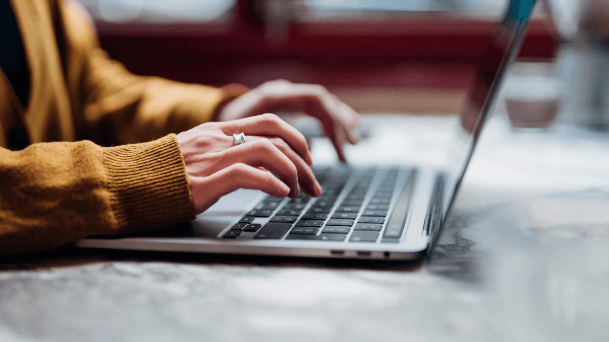 A woman typing on her computer.