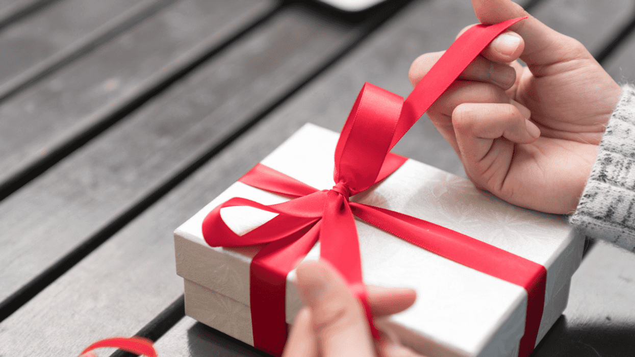 A woman unwrapping a present.