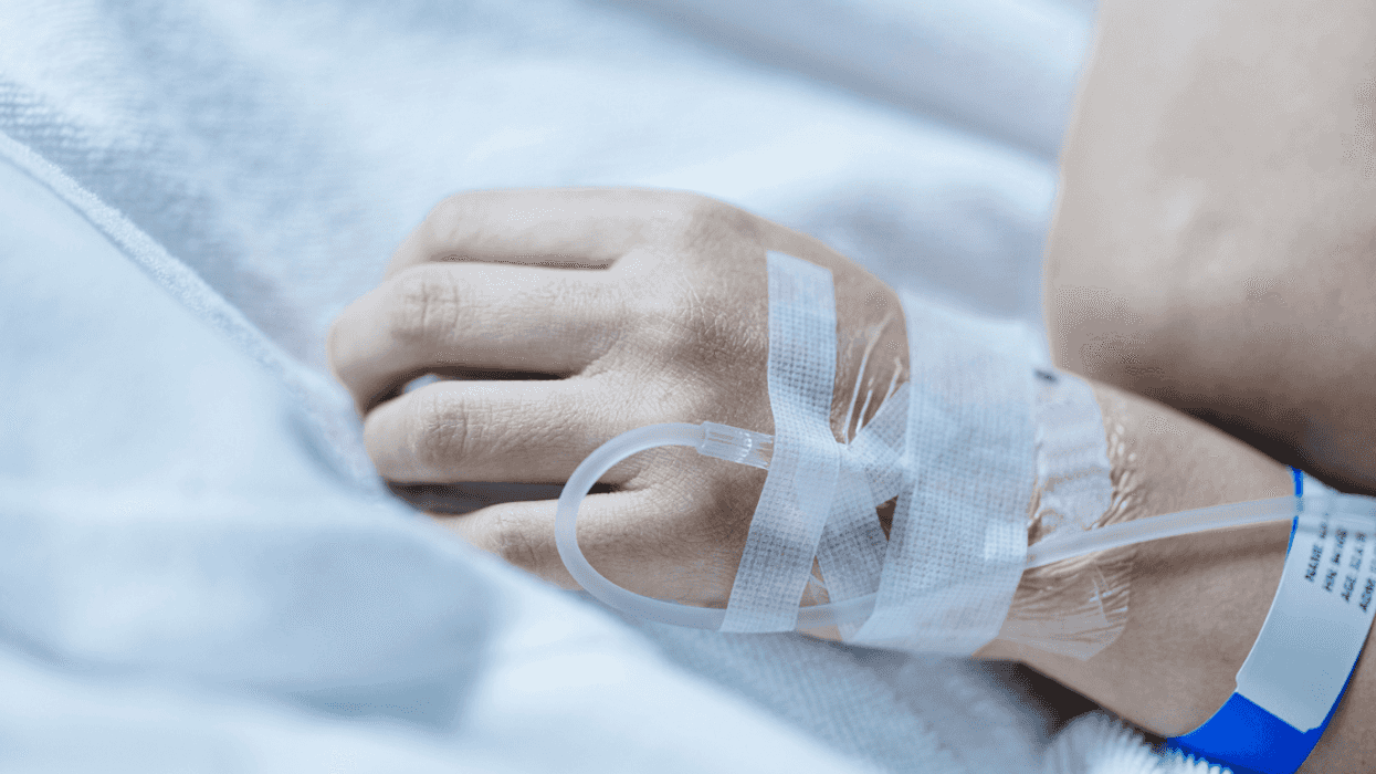 A woman with an IV attached to her arm.