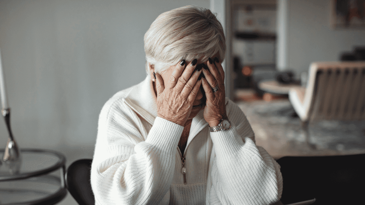 A woman with her head in her hands