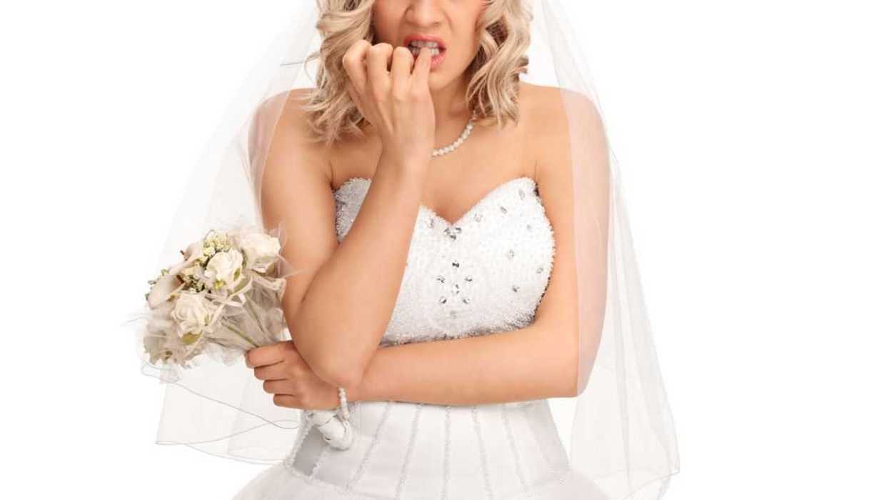 A worried bride chews her nails
