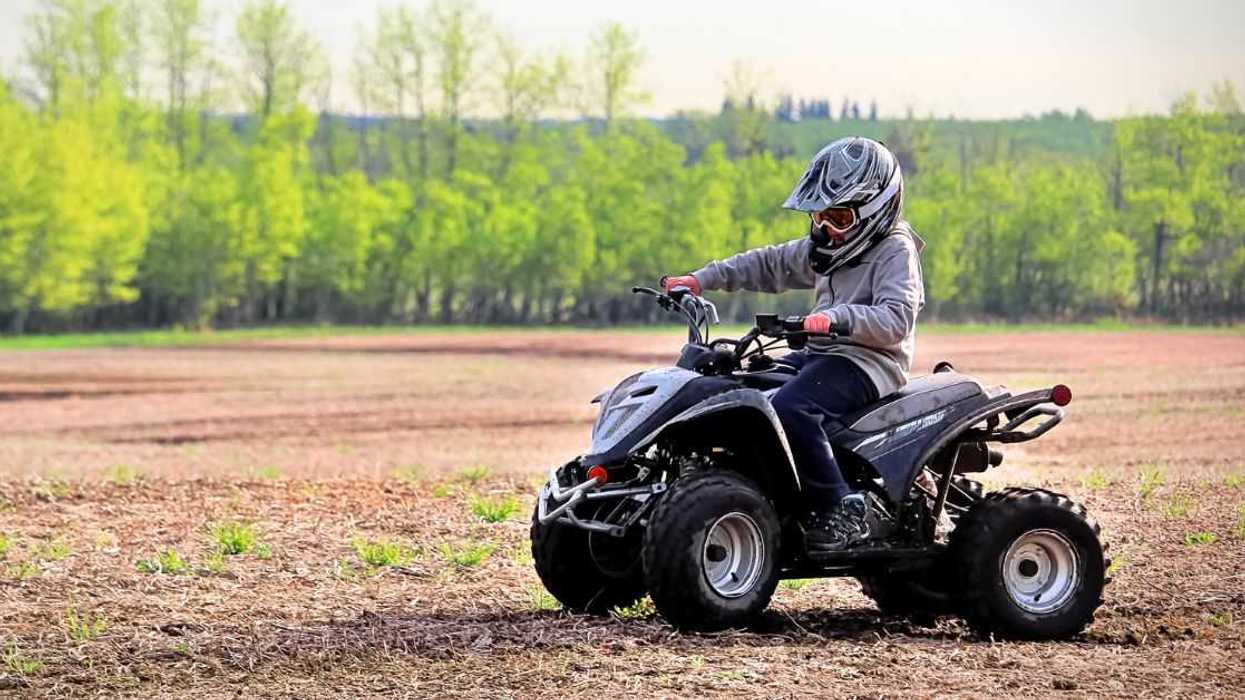 A young boy in a helmet rides an AV bike