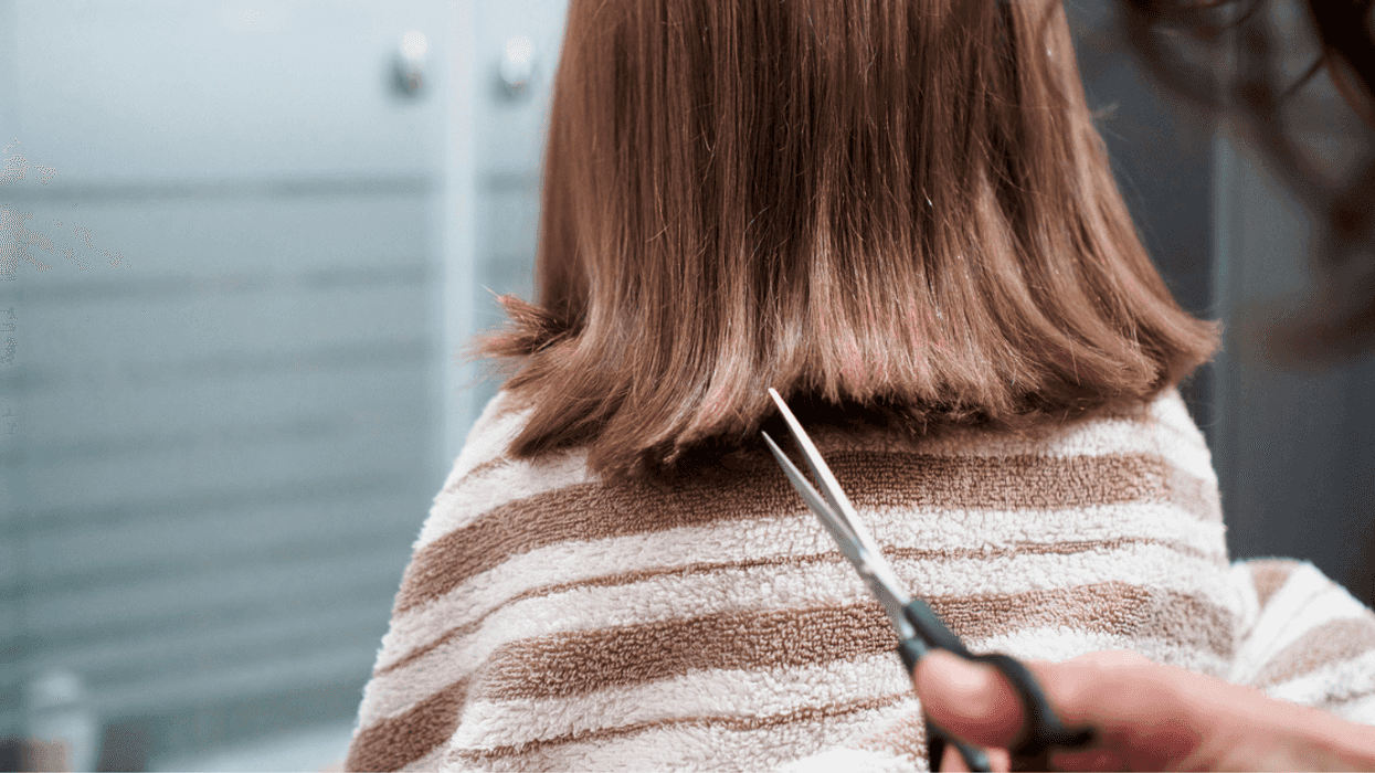 A young girl getting her hair cut.