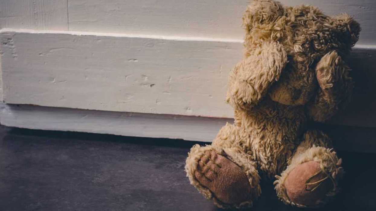 Abandoned Teddy Covering His Eyes, Sitting At A Door.
