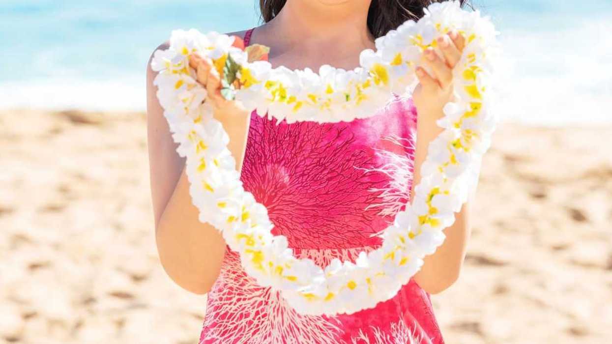 Aloha greeting with Hawaii flower lei on the beach.