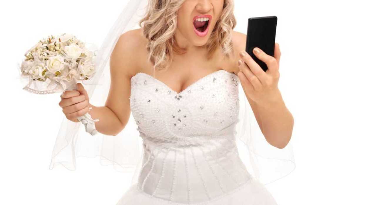 An angry bride looks into a phone
