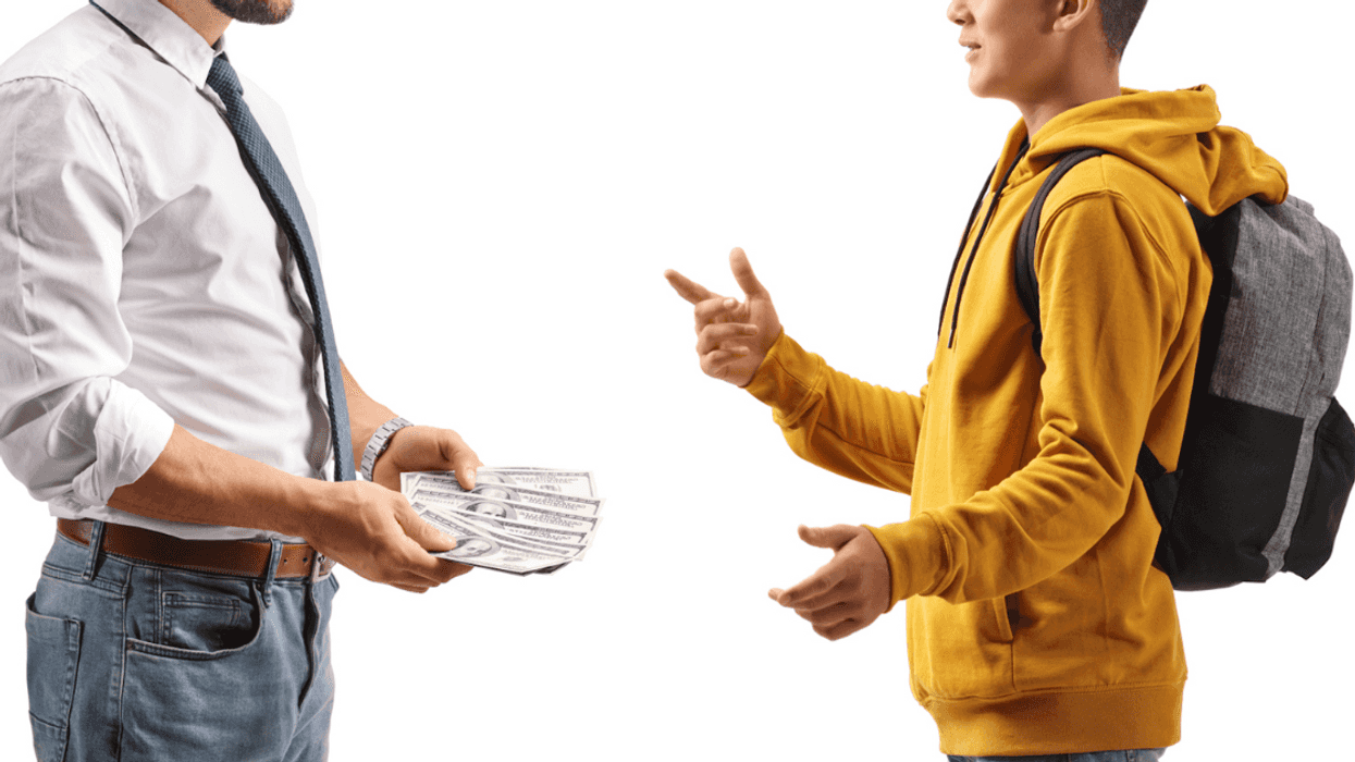 an older man with money in his hand facing a younger man gesturing at him.