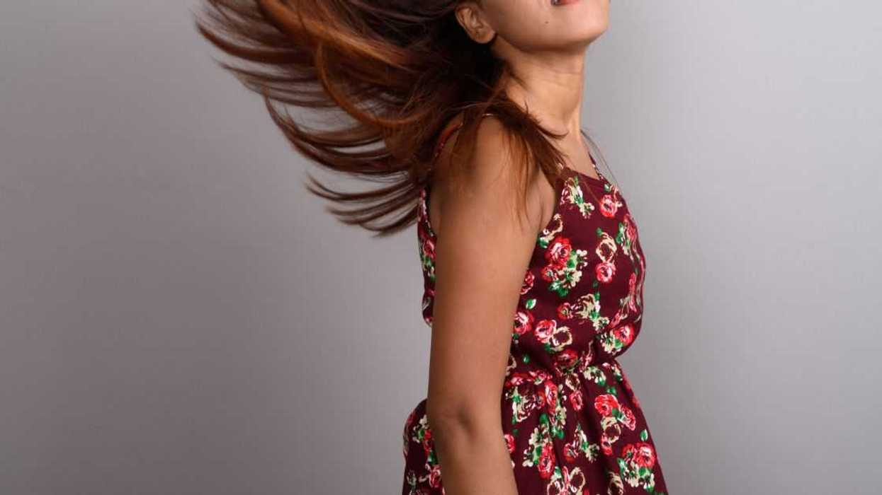 An young Indian girl in a floral print dress