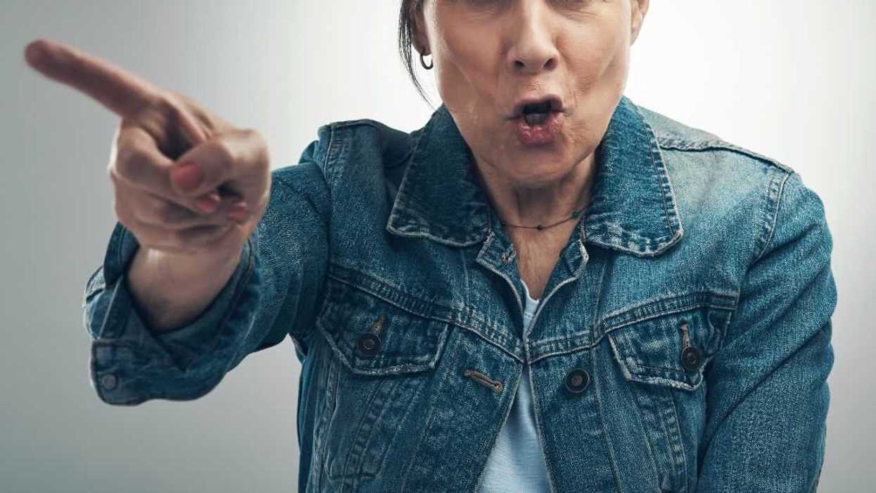 Angry elderly woman yelling and pointing