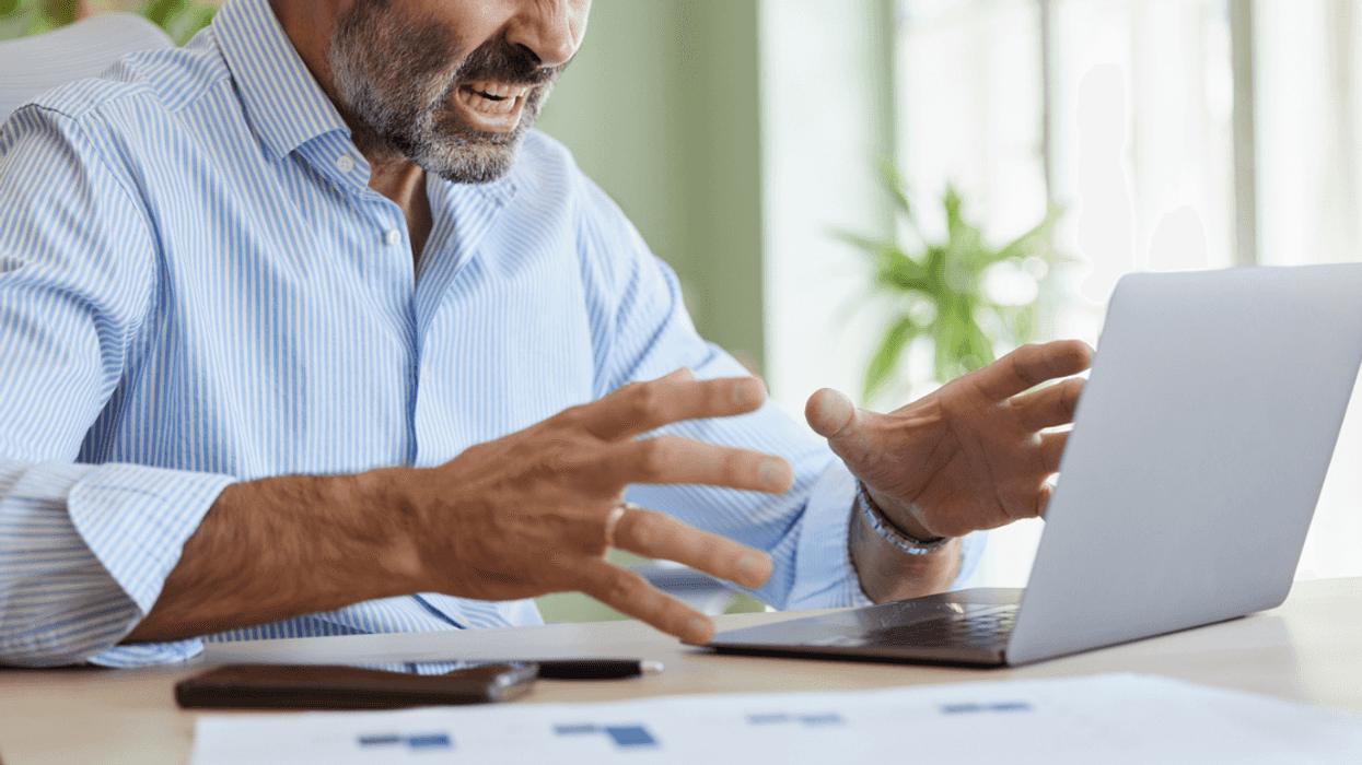 Angry guy looking at work computer