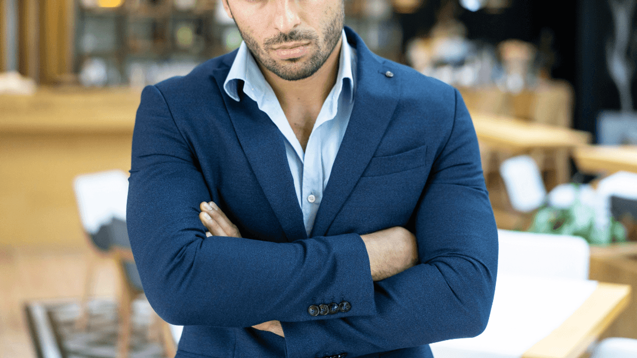 angry man in suit with arms crossed