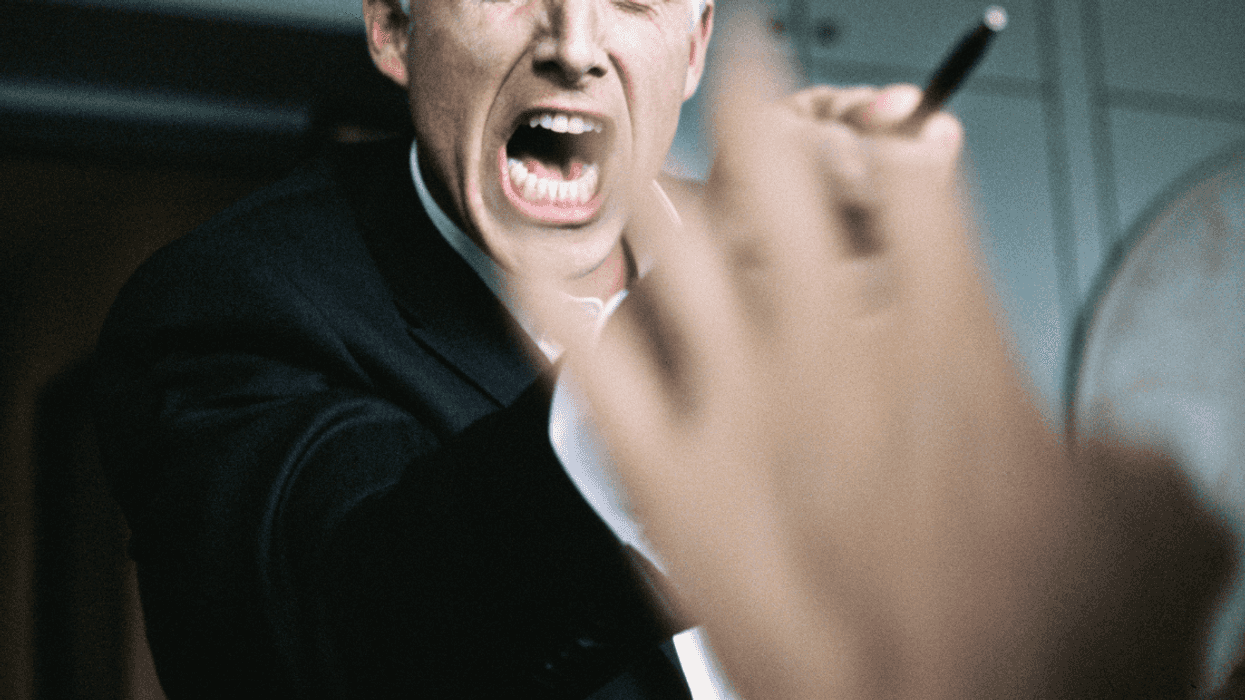 angry man yells and gestures at unseen person with hand up