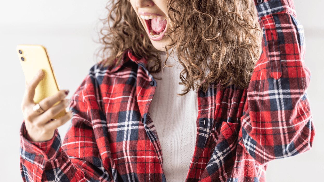 Angry woman looking at her phone