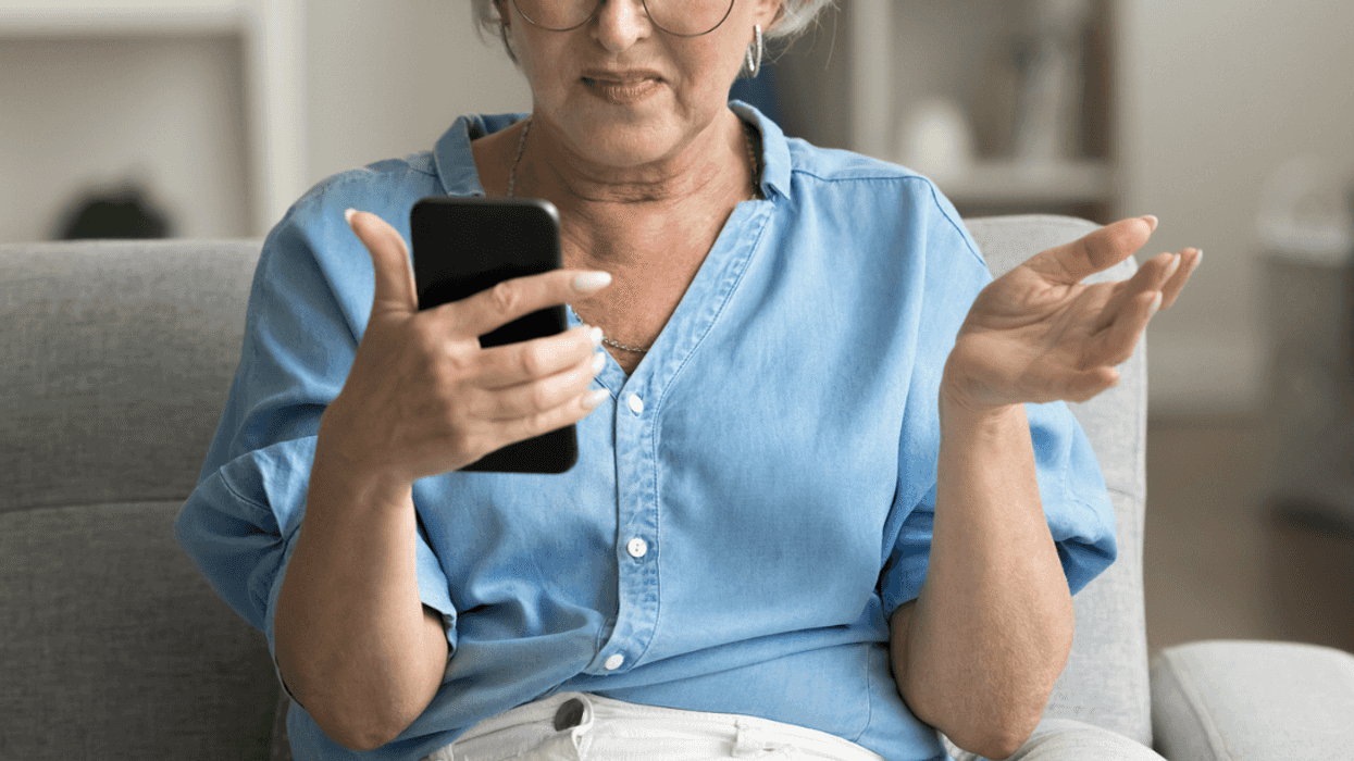 Angry woman looking at her phone