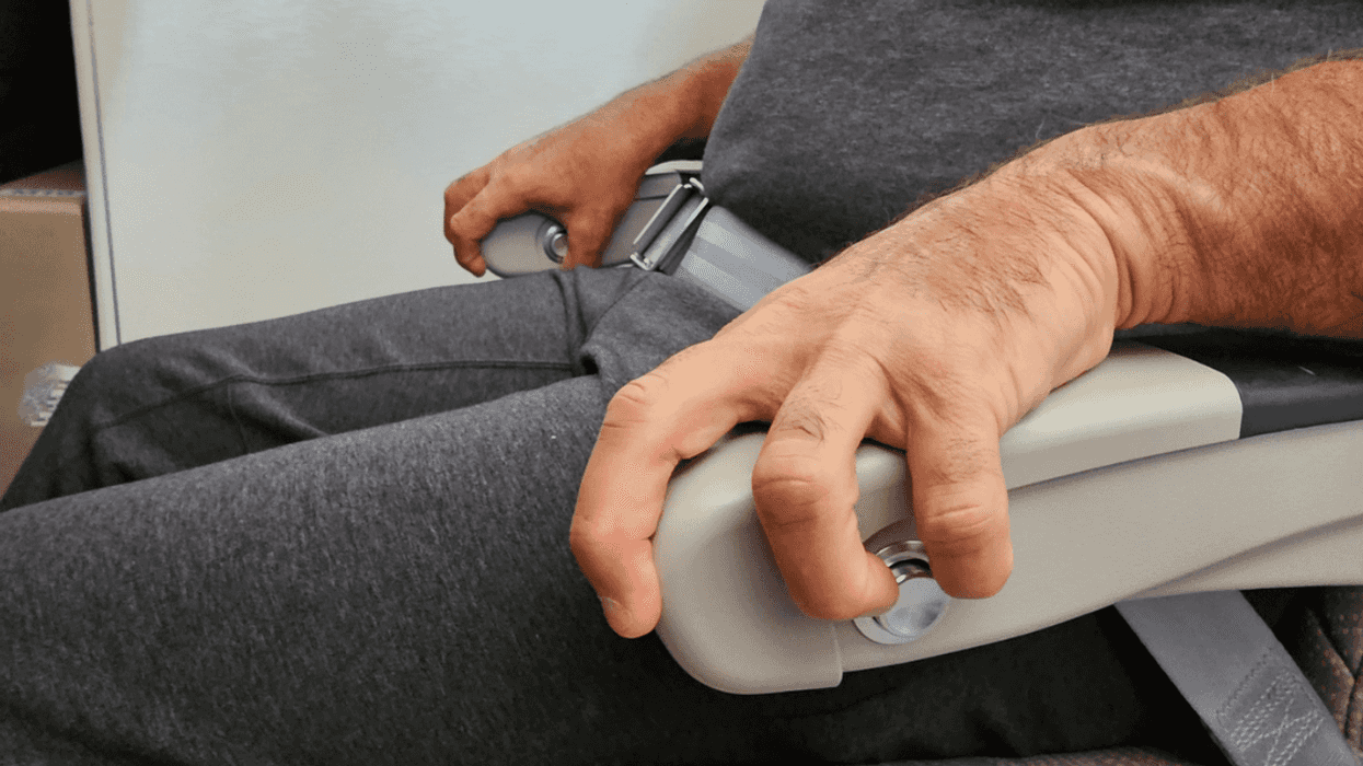 Anxious flyer gripping their armrests