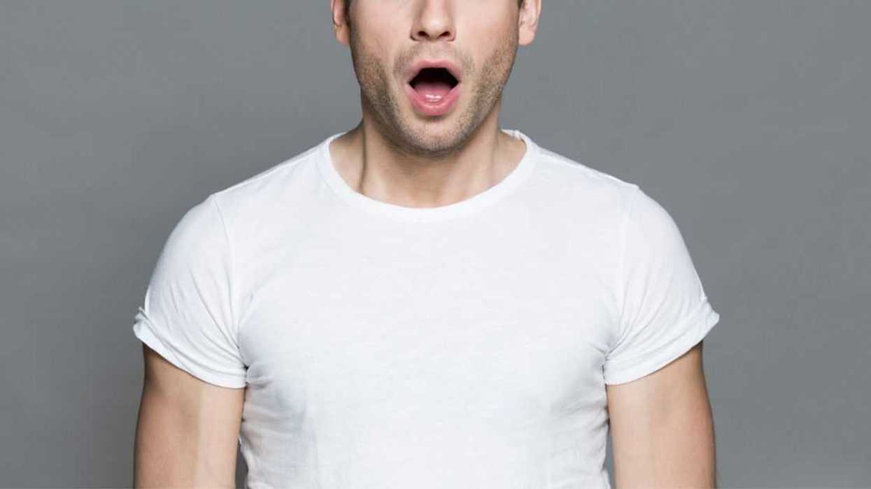 Astonished man in white T-shirt