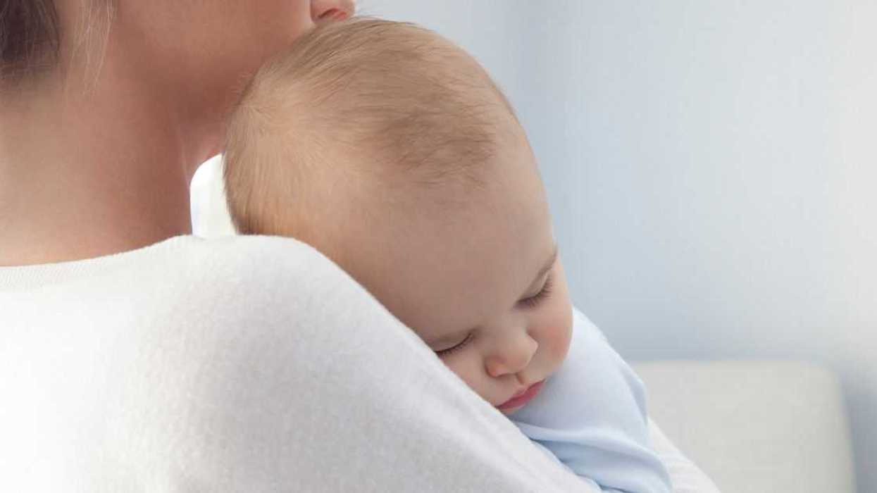 Baby Boy Sleeping In His mother's Arms