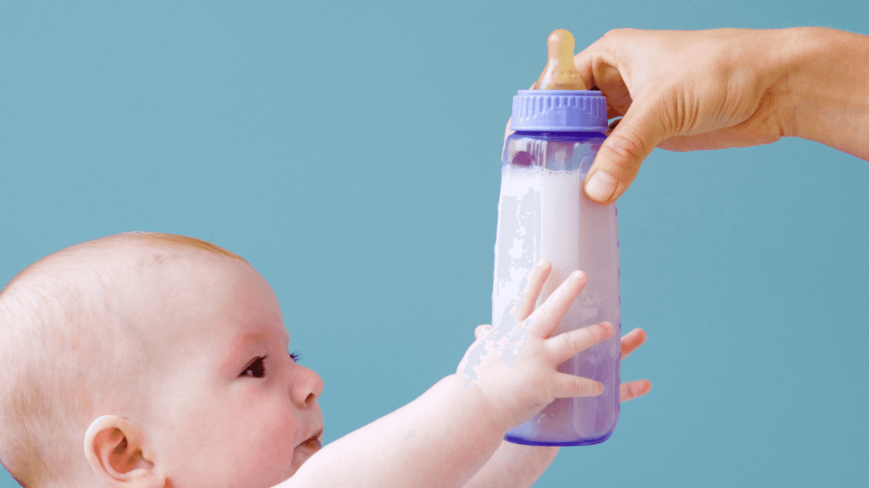 Baby reaching for bottle
